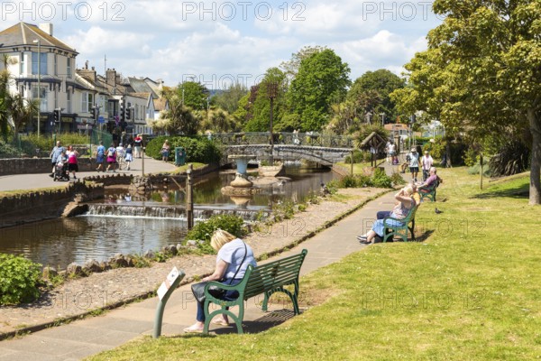 Dawlish Water river flowing through park gardens in town centre, Dawlish, south Devon, England, UK