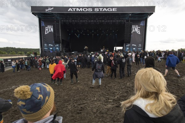Festival visitors dance in the mud in front of the Atmos Stage at the Rock am Ring Festival on Sunday, Nürburgring race track race track, 08.06.2025