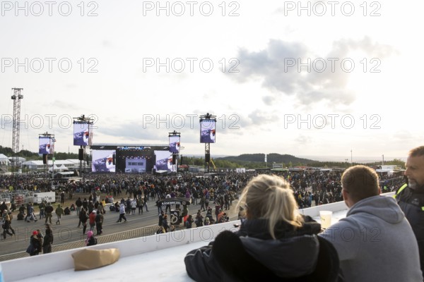 Festival-goers look at the Mandora Stage in the evening sun at the Rock am Ring Festival on Sunday, Nürburgring race track race track, 08.06.2025