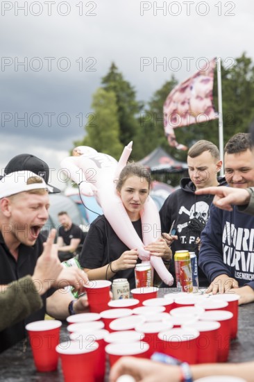 Festival visitors play a drinking game on a campsite at the Rock am Ring Festival on Saturday, Nürburgring race track race track, 07.06.2025