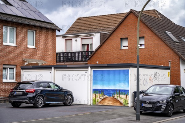 Residential neighbourhood, residential street in Dortmund-Marten, multi-family houses, garages, one with a beach-sea panorama painting, home