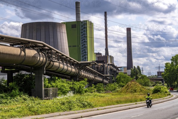 Pipelines for various gases, blast furnace gas, Thyssenkrupp Steel steelworks in Duisburg-Bruckhausen, in front the gas-fired Hamborn power station, green façade of boiler house Block5, North Rhine-Westphalia, Germany
