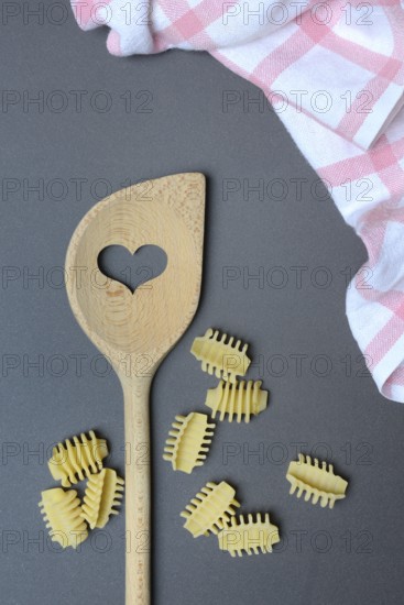 Cooking spoon with heart and Italian pasta, Radiatori variety