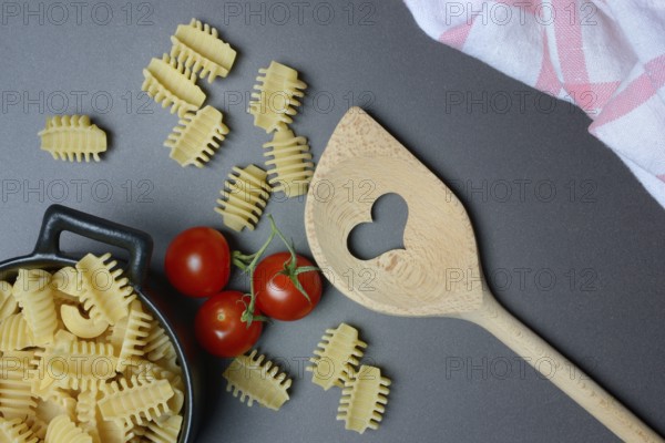 Cooking spoon with heart and Italian pasta, Radiatori variety