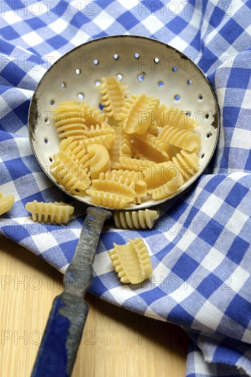 Italian pasta in a sieve, Radiatori variety