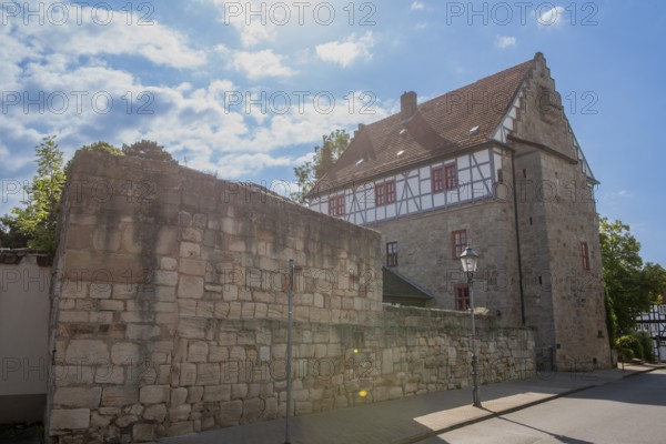 Restored Ratshof at the medieval town wall, Bad Sooden-Allendorf, district Allendorf, Steinernes Haus, former town hall, half-timbered house, lantern, street, backlight, blue sky, clouds, Werra-Meissner-Kreis, Hesse, Germany