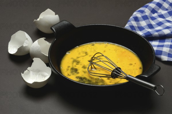 Cracked egg in a pan, hen's egg and eggshells