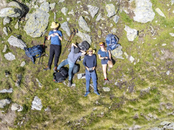 Group of mountaineers taking a break, rest with Ickerchen in the mountains, from above, Valais, Western Alps Switzerland