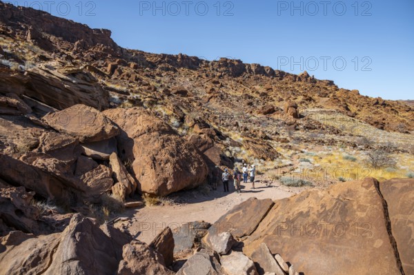 Tourists visiting the rock engravings of Twyfelfontein, Twyfelfontein, Kunene, Namibia