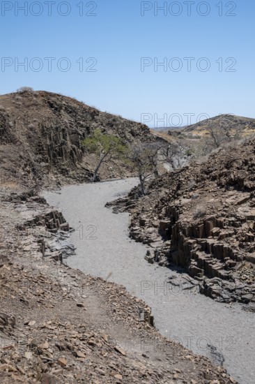 Dry river valley with basalt rocks, rock formation Organ Pipes, Damaraland, Kunene, Namibia