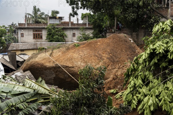 Large rock slides from the top of a hill and damaged houses in a major landslide, triggered by a heavy downpour, in Guwahati, India, on June 7, 2025. One person was reported missing in thr landslide and two houses damaged