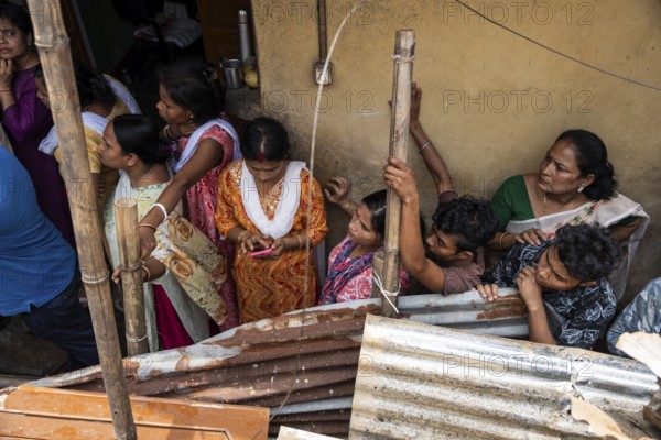 Residents looks as Rescue operations by the National Disaster Response Force (NDRF) and police are in full swing after a major landslide, triggered by a heavy downpour, in Guwahati, India, on June 7, 2025. One person was reported missing in thr landslide and two houses damaged