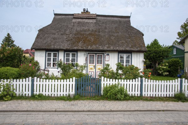 White thatched house with lovingly designed front garden. Wieck, Mecklenburg-Western Pomerania, Germany