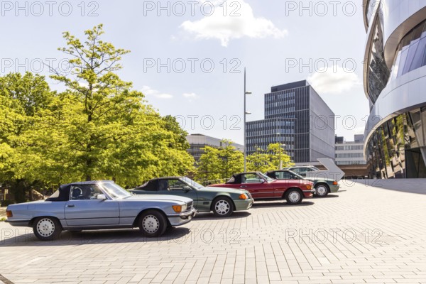 Headquarters of Mercedes-Benz Group AG in Untertürkheim. Next to it the Mercedes-Benz Museum, exterior view with classic cars. Stuttgart, Baden-Württemberg, Germany