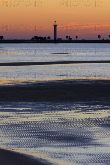 Sunrise silhouette of Broadwater Beach Marina Light at Biloxi, Mississippi, USA