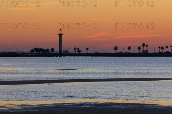 Sunrise silhouette of Broadwater Beach Marina Light at Biloxi, Mississippi, USA