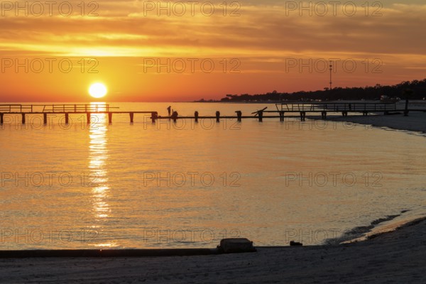 Sunset behind dilapidated fishing pier damaged by hurricanes on the Mississippi Gulf Coast in Long Beach, Mississippi