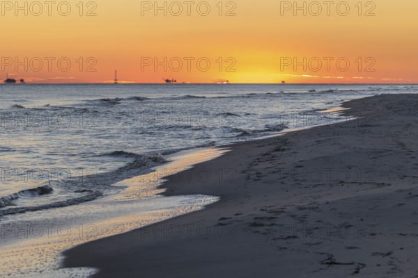 Oil and gas drilling rigs on the Gulf of Mexico horizon at Fort Morgan, Alabama, USA