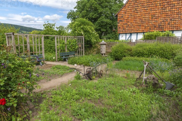 Church and Bible garden of St. Crucis Church, Bad Sooden, Allendorf, Allendorf district, symbol of paradise garden with biblical flora, beds, fruits of the field, agricultural implements, plough, forks, beekeeping in a log hive, resting benches, half-timbered house, Werra-Meissner district, Hesse, Germany