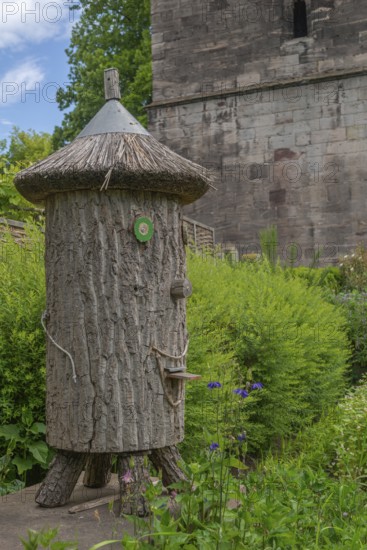 Church and Bible garden of St Crucis Church, Bad Sooden, Allendorf, Allendorf district, symbol for paradise garden with biblical flora, beekeeping in a log hive, tree trunk, thatched roof, Werra-Meissner district, Hesse, Germany