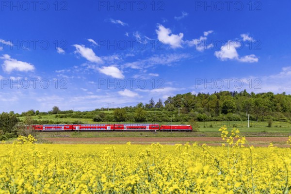 RegionalExpress RE5 en route on the Swabian Alb. Landscape along the railway line in spring. Lonsee, Baden-Württemberg, Germany