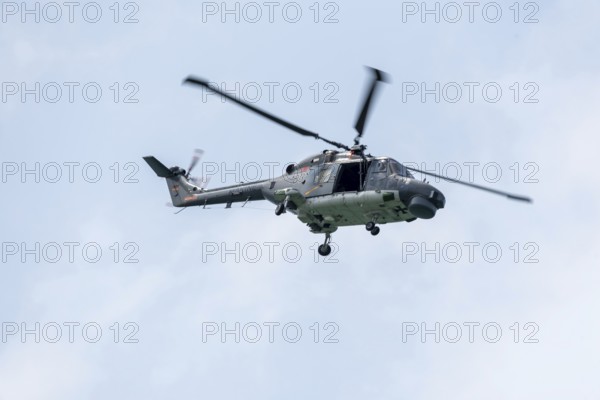 Naval helicopter flies in front of a clear sky, majestic and technical, Prerow, Mecklenburg-Vorpommern, Germany