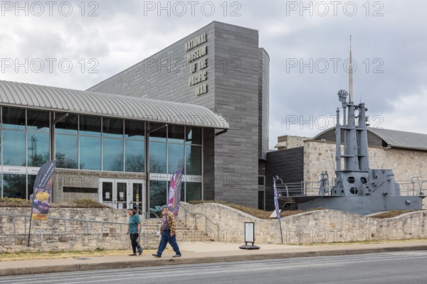 Senior couple walking past the National Museum of the Pacific War in Fredericksburg, Texas, USA