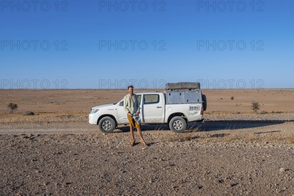 Tourist with off-road car on a sandy track, Brandberg, Damaraland, Namibia