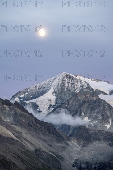 Summit Mont Blanc de Cheilon with glaciers, evening mood, moon stands over mountain peaks at the blue hour, Hérménence, Valais Alps, Valais, Switzerland