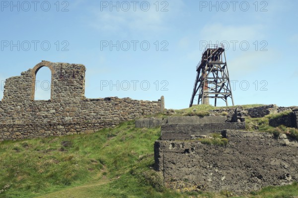 Mining ruins and a derelict tower stand on a grassy hill, engine room, mining, Botallack, Cornwall, England, Great Britain