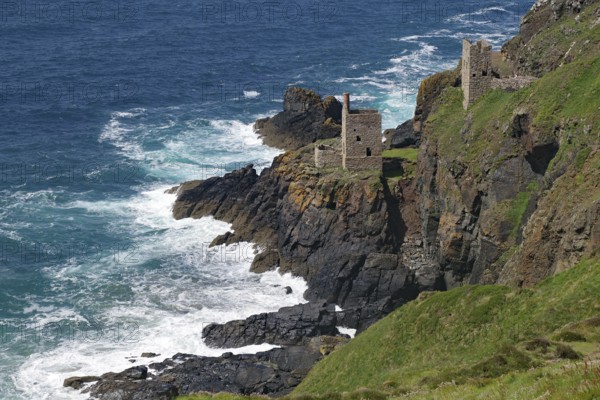 Historic ruins on a rocky cliff above the roaring sea and deep blue sky, engine room, mining, Botallack, Cornwall, England, Great Britain