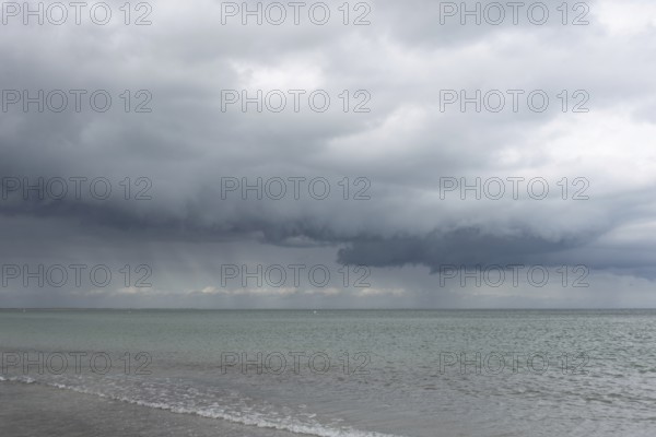 Thick, dark rain clouds gather over the Baltic Sea, Prerow, Mecklenburg-Vorpommern, Germany