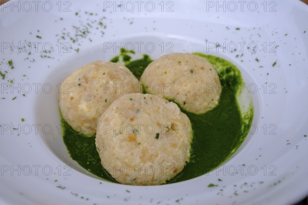 Dumplings on herbs, at Rifugio Ra Stua, Ra Stua Alm, Valon Scuro, near Cortina d'Ampezzo, Dolomites, Trentino, Italy
