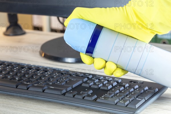 Office cleaning: Close-up of the cleaning of an office desk