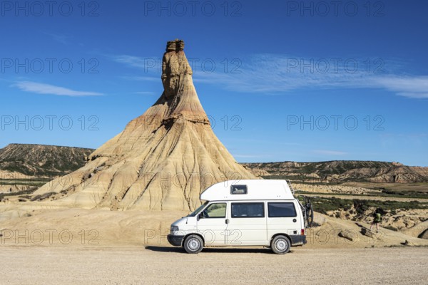Camper van in front of Castildetierra rock formation, semi-desert, Bardena Blanca area, Bardenas Reales Nature Park, Navarre, Spain