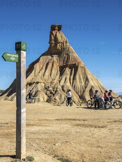 Group of cyclists, Castildetierra rock formation, semi-desert, Bardena Blanca area, Bardenas Reales Nature Park, Navarre, Spain