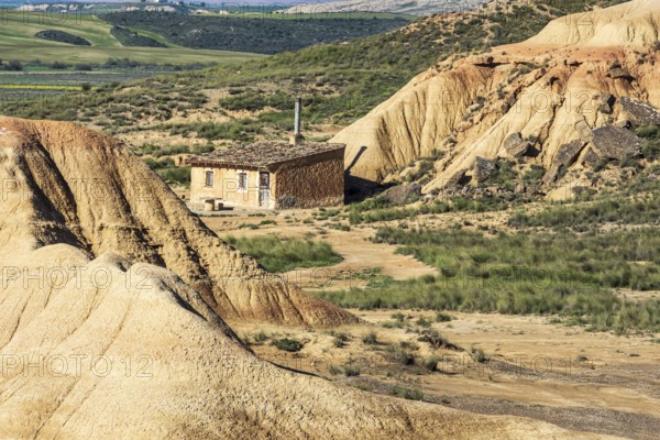 Colorful rock formation, smal hut, semi-desert, Bardena Blanca area, Bardenas Reales Nature Park, Navarre, Spain