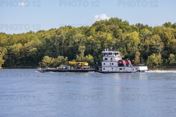 Tennessee Valley Authority tug boat Freedom pushing a barge with construction equipment upstream on the Tennessee River near Counce, Tennessee