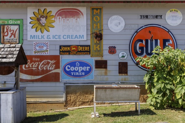 Antique metal advertising signs used for decoration on the side of a building near Counce, Tennessee
