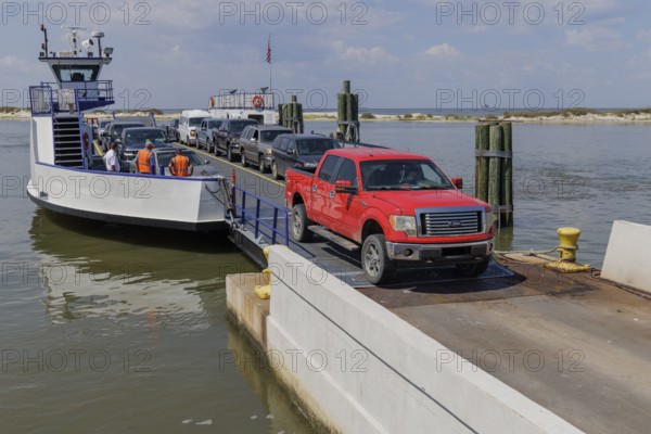 Vehicles driving off the Mobile Bay Ferry at Dauphin Island, Alabama