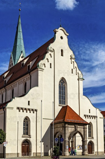 Gothic church with a high tower and red roofs under a blue sky, The town of Kempten in the Allgäu