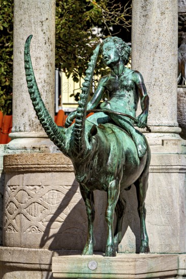 Bronze figure of a rider on a mystical animal, skilfully designed with long horns, The fountain in the town of Kempten im Allgäu