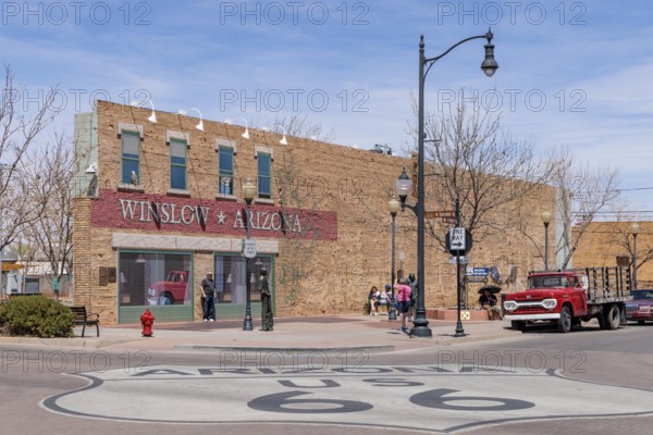 Tourists take photos Standin' on a Corner in Winslow Arizona as sung in the classic Glenn Frey and Jackson Browne song