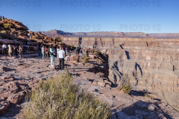 Tourists on the edge of the canyon at Guano Point area of Grand Canyon West near Peach Springs, Arizona