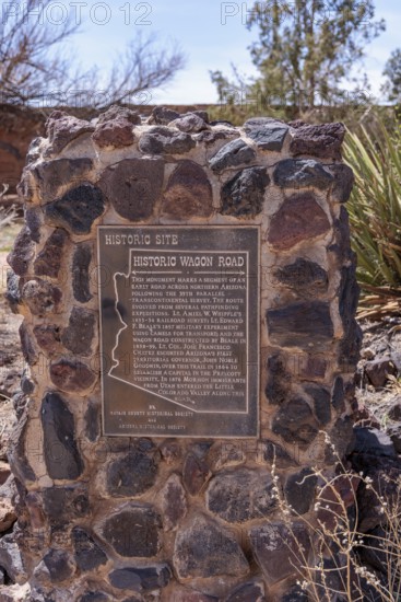 Plaque on stone historical marker provides information on the historic wagon road through Arizona near Winslow