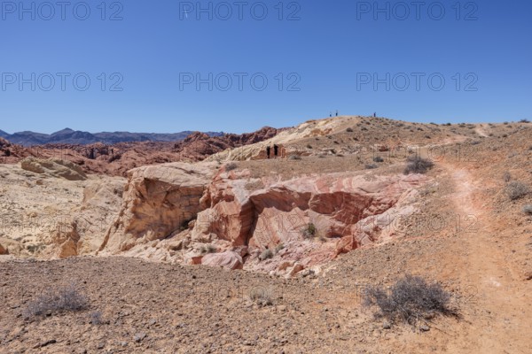 Hikers on the trail to an overlook at the end of Fire Canyon Road at Valley of Fire State Park near Overton, Nevada