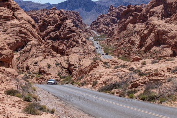 Traffic on Mouse's Tank Road winds between the red sandstone rock formations in Valley of Fire State Park near Overton, Nevada