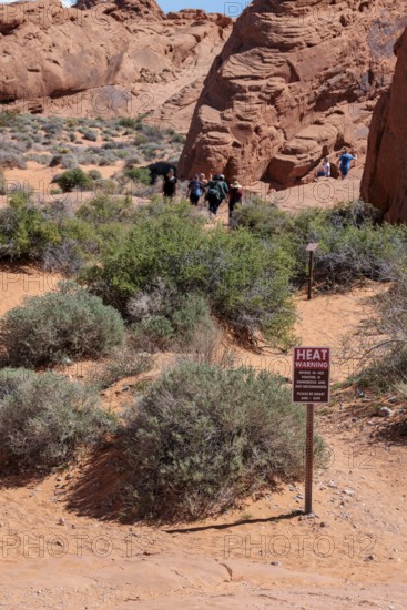 Sign at Fire Canyon Overlook Trailhead warns of hiking in hot weather at Valley of Fire State Park near Overton, Nevada