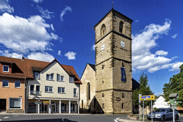 Central church tower in the village with surrounding buildings and streets under a blue sky, The church tower of the Protestant church of Creuzburg in Thuringia
