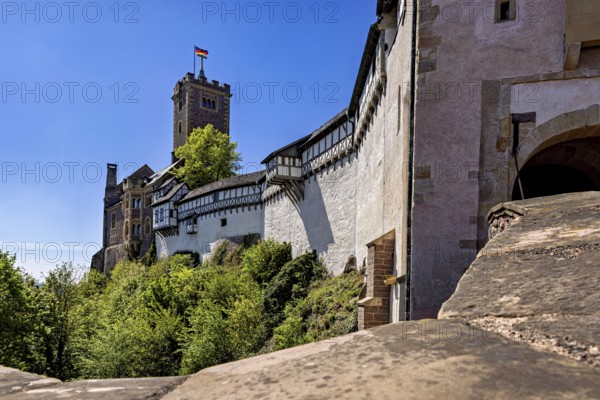 Castle walls with a view of the blue sky and flag, Wartburg Castle near Eisenach in Thuringia